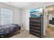 Cozy bedroom features a TV, dresser, and a window for natural light at 2911 W Hawanian Ln, Monrovia, IN 46157