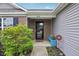 Covered front porch featuring brick accents, stylish decor, and low maintenance landscaping at 2911 W Hawanian Ln, Monrovia, IN 46157