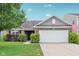 Charming home featuring a two-car garage, landscaped yard, and brick and vinyl siding at 2911 W Hawanian Ln, Monrovia, IN 46157