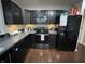 Modern kitchen with black appliances, countertops and cabinetry at 2911 W Hawanian Ln, Monrovia, IN 46157