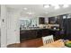 Modern kitchen featuring dark cabinets, stainless steel appliances, and an adjacent pantry at 2911 W Hawanian Ln, Monrovia, IN 46157