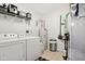 Functional laundry room features a washer, dryer, and storage shelves at 2911 W Hawanian Ln, Monrovia, IN 46157