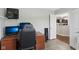 Office boasts a desk, monitors, and an open doorway to the kitchen at 2911 W Hawanian Ln, Monrovia, IN 46157