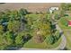 Drone view of the property highlighting the pool, outbuildings, and mature trees at 2956 N 700 E, Franklin, IN 46131
