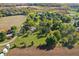 An aerial view showing the proximity to other homes, a pond, and farmland at 2956 N 700 E, Franklin, IN 46131
