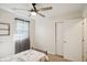 Bright bedroom features a ceiling fan, carpeted floor, window with sheer curtains, and a closet with sliding doors at 2956 N 700 E, Franklin, IN 46131