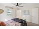 Bright bedroom featuring a ceiling fan, window, carpeted floor, double bed and multiple closets at 2956 N 700 E, Franklin, IN 46131