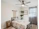 Bright bedroom with a ceiling fan, single bed, carpeted floor, and window with sheer curtains and decorative furnishings at 2956 N 700 E, Franklin, IN 46131