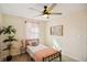 Bright bedroom features a ceiling fan, single bed, carpeted floor, and windows with pink sheer curtains and side tables at 2956 N 700 E, Franklin, IN 46131