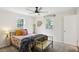 Bright bedroom with two windows, ceiling fan, carpeted floor, double bed and bench at 2956 N 700 E, Franklin, IN 46131