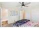 Bright bedroom featuring a ceiling fan, window, carpeted floor, double bed, bathroom door and multiple closets at 2956 N 700 E, Franklin, IN 46131