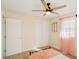 Bedroom features a ceiling fan, double closets, carpeted floor, window with pink sheer curtains, and a single bed at 2956 N 700 E, Franklin, IN 46131