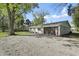 Single-story home featuring a two-car garage, landscaped yard, and mature trees at 2956 N 700 E, Franklin, IN 46131