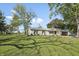 Charming ranch home with a lush front yard and mature trees on a sunny day at 2956 N 700 E, Franklin, IN 46131