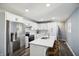 Bright kitchen featuring stainless steel appliances, white cabinets, a breakfast bar, and modern finishes at 2956 N 700 E, Franklin, IN 46131