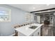 Bright kitchen featuring an island breakfast bar, wooden chairs, and views into the dining area at 2956 N 700 E, Franklin, IN 46131