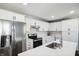 Bright kitchen featuring stainless steel appliances, white cabinets, a breakfast bar, and modern finishes at 2956 N 700 E, Franklin, IN 46131