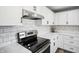 Bright kitchen featuring white cabinets, modern appliances, tile backsplash and modern countertop at 2956 N 700 E, Franklin, IN 46131