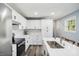 Bright kitchen featuring stainless steel appliances, white cabinets, a breakfast bar, and modern finishes at 2956 N 700 E, Franklin, IN 46131