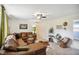 Spacious living room with a plush sectional sofa, ceiling fan, and natural light at 2956 N 700 E, Franklin, IN 46131