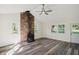 Bright living room featuring a brick fireplace, wood floors, and natural light at 2956 N 700 E, Franklin, IN 46131