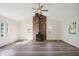 Bright living room featuring a brick fireplace, wood floors, and natural light at 2956 N 700 E, Franklin, IN 46131