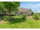 Landscaped backyard featuring a deck, beautiful garden, mature trees, and plenty of space at 3631 S 450 E, Whitestown, IN 46075