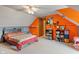 Bedroom features an orange accent wall, sloped ceilings, and a carpeted floor at 3631 S 450 E, Whitestown, IN 46075