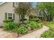 Beautiful landscaping and a winding sidewalk to the quaint covered front porch at 3631 S 450 E, Whitestown, IN 46075