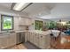 Modern kitchen with stainless steel appliances adjacent to a bright, plant-filled living room at 3631 S 450 E, Whitestown, IN 46075