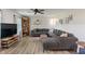Bright living room featuring a comfortable sofa, ceiling fan, and a large window at 3631 S 450 E, Whitestown, IN 46075