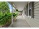 Inviting covered porch featuring a bench and lush landscaping surrounding the home at 3631 S 450 E, Whitestown, IN 46075