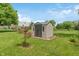 Backyard shed on a lush green lawn offers extra storage space for outdoor equipment and tools at 3631 S 450 E, Whitestown, IN 46075