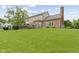 Large backyard with green lawn, deck and brick house view, perfect for outdoor activities and relaxation at 3708 Gould Dr, Carmel, IN 46033