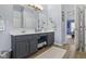 Double sink vanity and makeup station with a comfortable stool in the updated bathroom at 3708 Gould Dr, Carmel, IN 46033