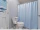 Clean bathroom featuring a toilet with a blue curtain, towel and fixtures at 3708 Gould Dr, Carmel, IN 46033