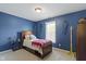 Bright bedroom features blue painted walls and hockey themed decor at 3708 Gould Dr, Carmel, IN 46033