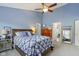 Bright bedroom with a ceiling fan, dresser, and a decorative mirror reflecting the bathroom at 3708 Gould Dr, Carmel, IN 46033