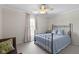 Cozy bedroom featuring a bed, a window with curtains and a ceiling fan at 3708 Gould Dr, Carmel, IN 46033