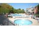 Community pool with lounge chairs surrounded by trees and a fence at 3708 Gould Dr, Carmel, IN 46033