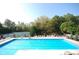 Large community pool with multiple lounge chairs, tennis courts, and trees at 3708 Gould Dr, Carmel, IN 46033