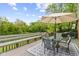 Outdoor deck overlooking lush backyard and pond, complete with outdoor seating and a relaxing hammock at 3708 Gould Dr, Carmel, IN 46033