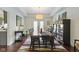 Spacious dining room features a long table, stylish decor, and ample natural light, ideal for gatherings at 3708 Gould Dr, Carmel, IN 46033