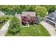 Beautiful brick home with well-manicured lawn and mature trees near a pond at 3708 Gould Dr, Carmel, IN 46033