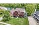 Beautiful brick home with mature trees and a well-manicured lawn overlooking a serene pond at 3708 Gould Dr, Carmel, IN 46033
