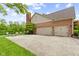 Home exterior featuring a three-car garage, brick accents and side patio area with seating at 3708 Gould Dr, Carmel, IN 46033
