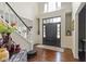 Bright and inviting foyer featuring hardwood floors, a staircase, and elegant decor at 3708 Gould Dr, Carmel, IN 46033