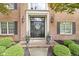 Charming brick home featuring a welcoming front door with decorative accents and manicured landscaping at 3708 Gould Dr, Carmel, IN 46033