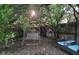 Relaxing backyard featuring a swing and patio seating nestled among lush greenery at 3745 Winthrop Ave, Indianapolis, IN 46205