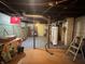 Unfinished basement with open ceiling, concrete walls, water heater, and support beams at 3745 Winthrop Ave, Indianapolis, IN 46205